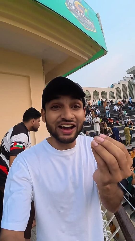 Waleed talking to camera on a cricket stadium concourse in Lahore